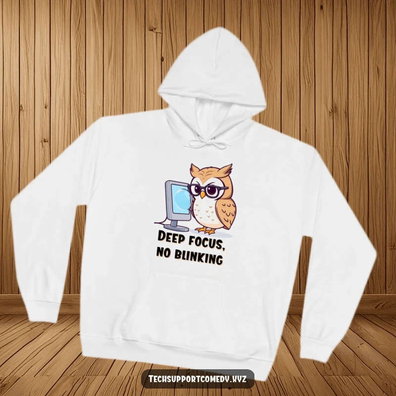 Comfortable funny owl in small glasses peering intently at a glowing computer screen with a magnifying glass on a hoodie.